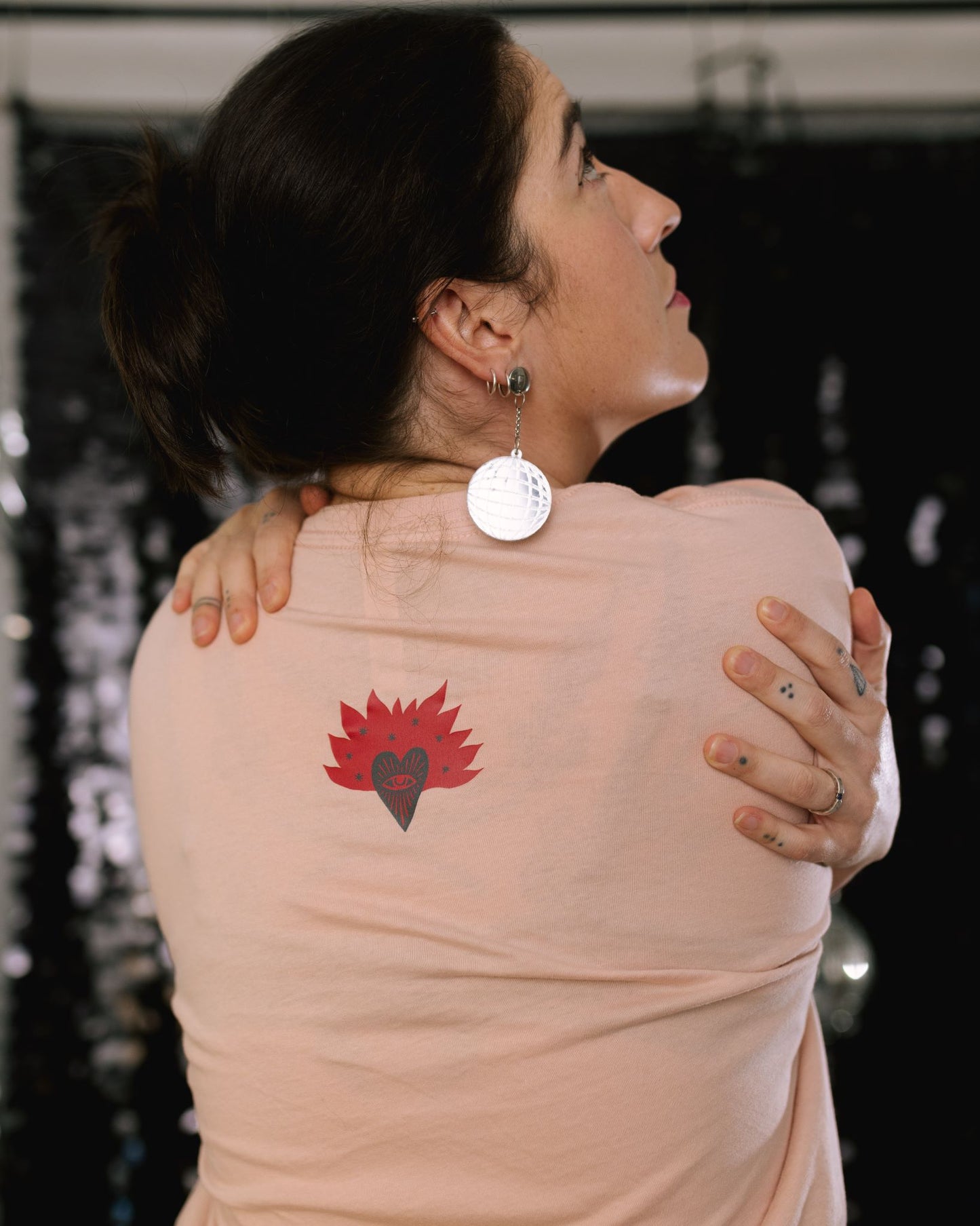 Graphic t-shirt with a bold message that revolution starts with love and self-change.