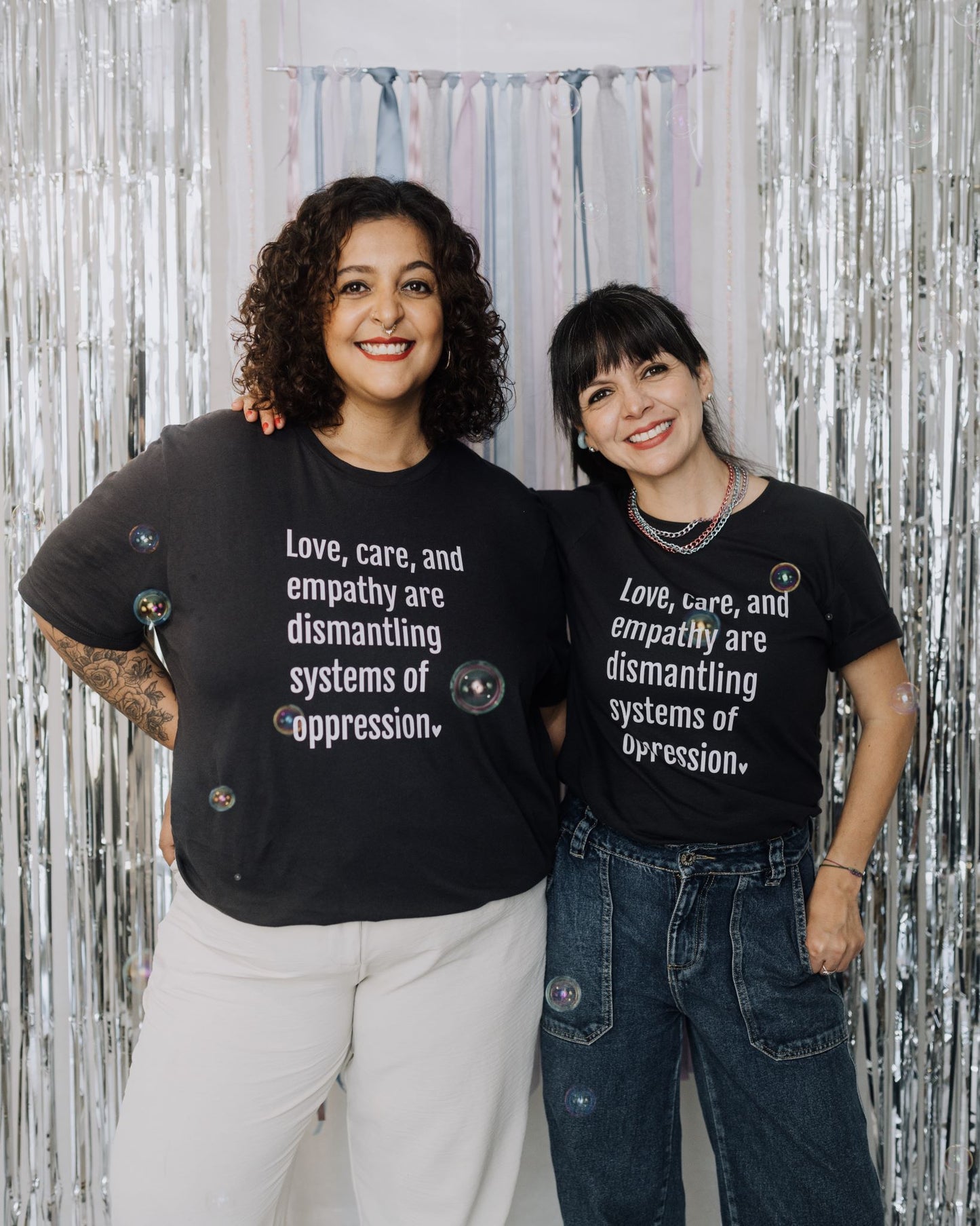 Graphic t-shirt with a powerful message that amplifies the revolutionary power of love and empathy at the core of liberation.