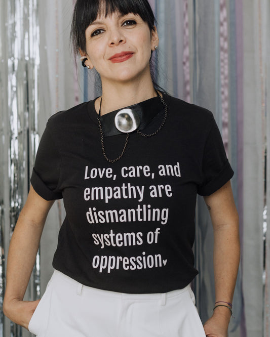 Feminist graphic t-shirt promoting the idea that love is revolutionary and essential for liberation.