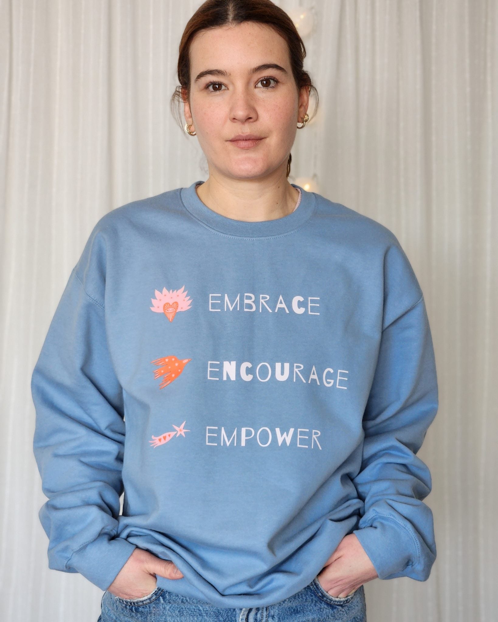 Person in a sweatshirt with a message to foster understanding and respect, celebrating uniqueness in society.