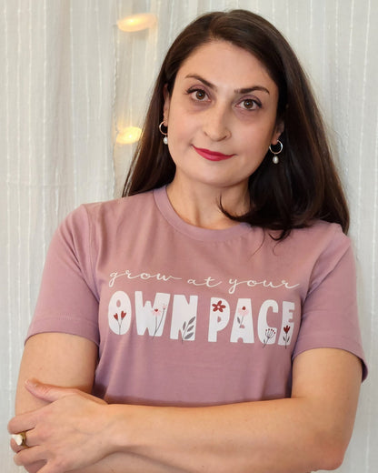 Person in a cotton graphic tee featuring a message that celebrates self-love and advocates for living intentionally.